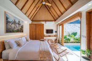 a bedroom with a large bed and a pool at Tropicool Hideaway Villas in Nusa Lembongan