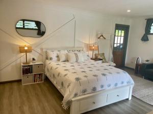 a bedroom with a white bed with a palm tree blanket at Horseshoe Haven in Horseshoe Bay
