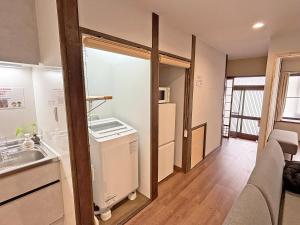 a small kitchen with a sink and a refrigerator at 東寺の宿夏 in Kyoto +28 photos