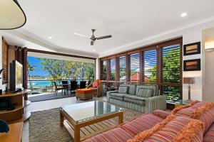 a living room with a couch and a table at Nouvelle in Noosaville