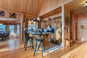 a kitchen with wooden floors and wooden walls at Fiddler Lake Resort - Deer 41 in Mille-Isles