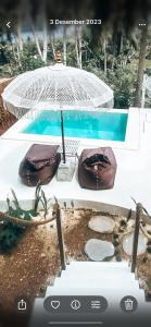 a view of a table with an umbrella and a pool at Exotic private glamping in Nusa Penida +13 photos