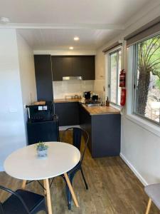 a kitchen and dining room with a table and chairs at Noojee views - cozy studio in Noojee