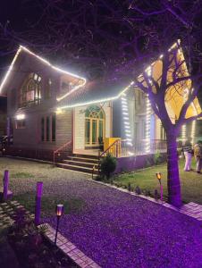 a house with lights on the front of it at Birdsong pahalgam in Pahalgām