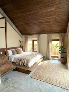 a bedroom with a large bed and a large window at Sum Homestay Hue - Gần cầu Nguyễn Hoàng in Hue
