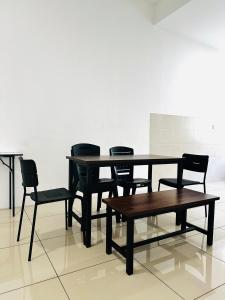 a table and chairs and a table and a table and chairs at The Luxe Permata by Haffa in Lunas +20 photos