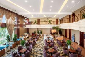 a hotel lobby with tables and chairs in a room at 都江堰国堰宾馆 in Dujiangyan