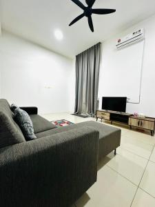 a living room with a couch and a ceiling fan at The Luxe Permata by Haffa in Lunas