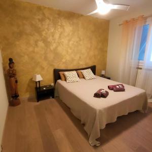 a bedroom with a bed with two bags on it at appartement dans villa aquarelle in Biguglia