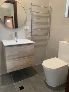 a bathroom with a sink and a toilet and a mirror at Bentworth Lodge in Carramar +35 photos