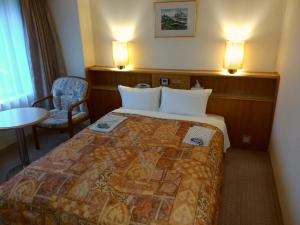 Postel nebo postele na pokoji v ubytování Hotel New Green Kashiwazaki