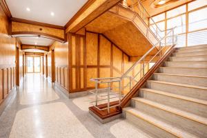 a staircase in a building with wooden walls at Chatsuree Mansion in Ubon Ratchathani +30 photos