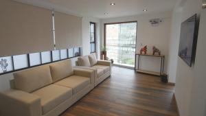 a living room with a couch and a table at MAKEYA Home-Hotel in Churín +20 photos