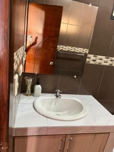 a bathroom with a white sink and a mirror at no está activo in Salinas