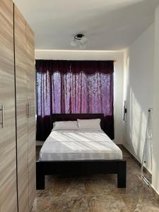 a bedroom with a bed in front of a window at no está activo in Salinas