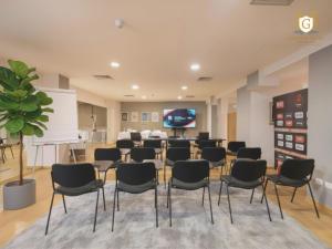 a conference room with chairs and a screen at Gaarten Hotel Benessere Spa by Kleos Group Collection in Gallio +194 photos