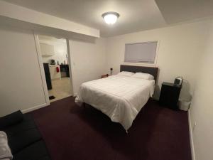 a bedroom with a bed with a white comforter at Tree Star Motel in Monroeton