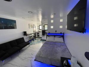 a bedroom with a bed and a living room at Tree Star Motel in Monroeton