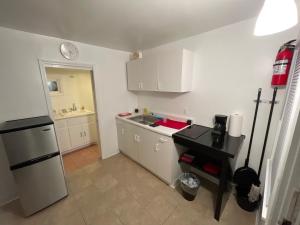 a small kitchen with a sink and a refrigerator at Tree Star Motel in Monroeton
