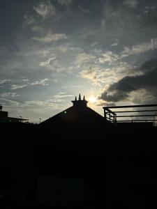 a silhouette of a building under a cloudy sky at Yatra Chhen in Bhaktapur
