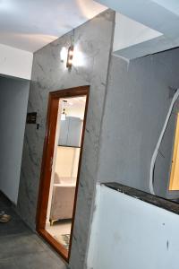 a room with a mirror and a wall with a door at Beach front flat in Bhīmunipatnam