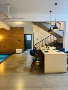 a kitchen with a table and chairs in a room at Mack Win Villa in Pannipitiya
