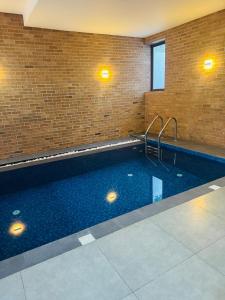 a large swimming pool in a brick building at Mack Win Villa in Pannipitiya
