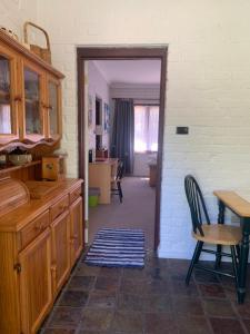a kitchen with a table and a dining room at Bentworth Lodge in Carramar