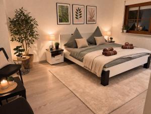 a bedroom with a large bed with pillows on it at Luxury Rhine Retreat Garten&Sauna in Busingen am Hochrhein