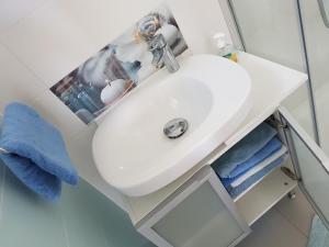 a white sink in a bathroom with a mirror at Cro Behar 2 Apartments in Sveti Petar +52 photos