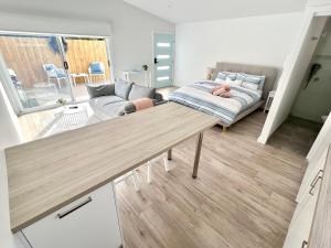 a living room with a couch and a table at Private Barwon Heads Cottage Walk to River in Barwon Heads
