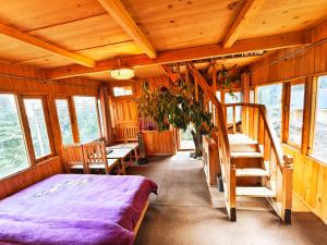 a bedroom with a bed and stairs in a cabin at Lambri View Treehouse Jibhi in Jibhi +27 photos