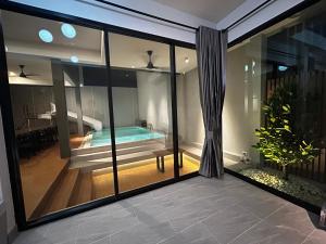 a view of a swimming pool from the balcony of a house at บลูด้าพูลวิลล่าซี Bludapoolvilla C in Ban Khlong Toei (1)