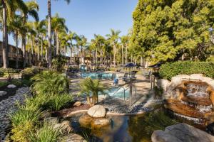 a pool in a resort with palm trees at Sheraton La Jolla in San Diego