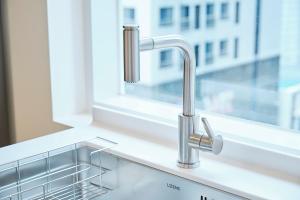 a kitchen sink with a window and a kitchen sink at Canvas Hostel in Busan +45 photos