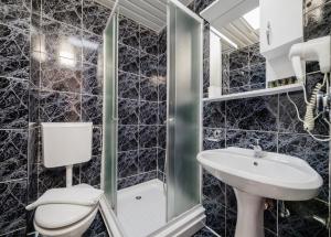 ein Badezimmer mit Toilette und Waschbecken in der Unterkunft Hotel Azzurro in Herceg-Novi + 85 Fotos