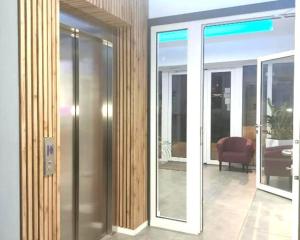 a glass door of a building with a balcony at Hotel Amber in Raszyn +71 photos