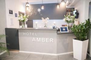 a hotelier counter in a room with potted plants at Hotel Amber in Raszyn