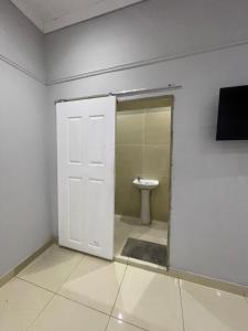 a bathroom with a white door and a toilet at Davidson Lodge in Goodwood
