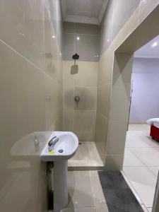 a bathroom with a sink and a shower at Davidson Lodge in Goodwood