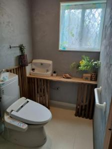 a bathroom with a toilet and a window at ほぬのいえ Honu's house in Uruma +54 photos
