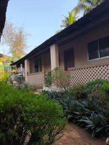 a house with a bunch of plants in front of it at janaki Homestay in Gokarna
