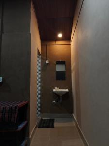 a bathroom with a sink on the wall at janaki Homestay in Gokarna