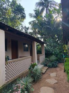 a house with a fence in front of a yard at janaki Homestay in Gokarna