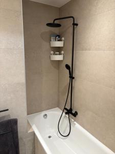 a shower in a bathroom with a bath tub at Spacious duplex apartment in Overijse in Overijse