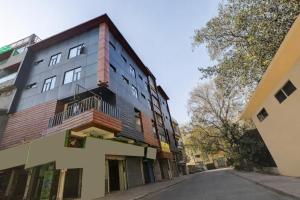 an apartment building on the side of a street at Hotel Ashram View With Luxury Near Nizamuddin Railway Station in New Delhi