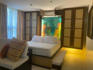 a small bedroom with a bed and a window at Carola Pico De Loro in Nasugbu +27 photos