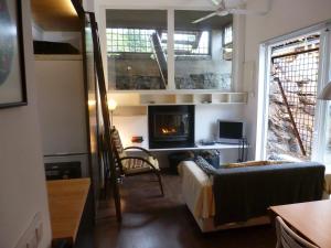 a living room with a couch and a fireplace at Apartment Rovellada Platja in Colera