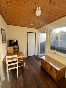 a dining room with a table and a window at Bungalow Beate in Zinnowitz