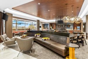 a hotel lobby with a couch and a bar at SpringHill Suites by Marriott Columbus West in Columbus